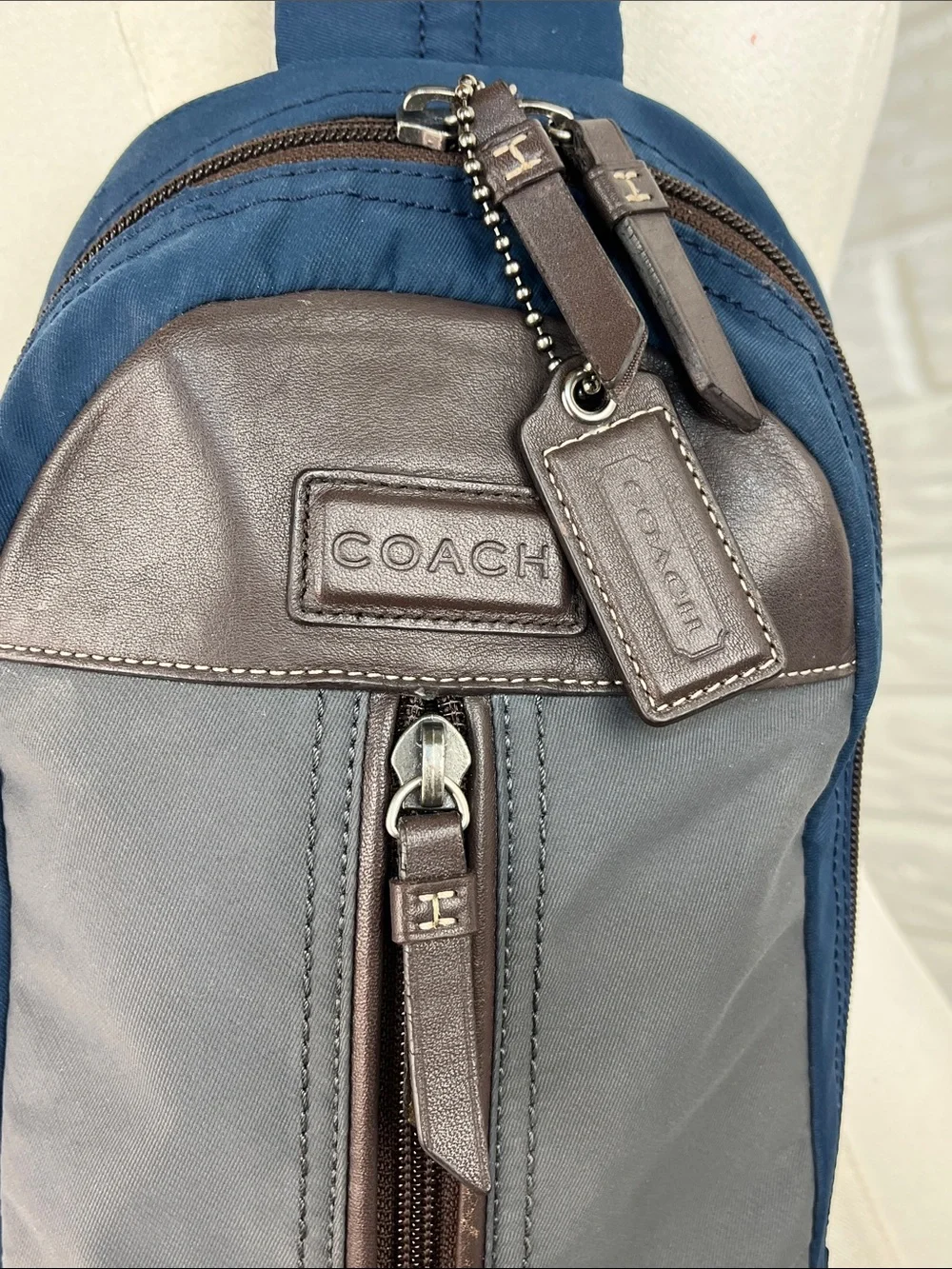 COACH Varick sling bag in navy blue / gray nylon with brown leather trim
